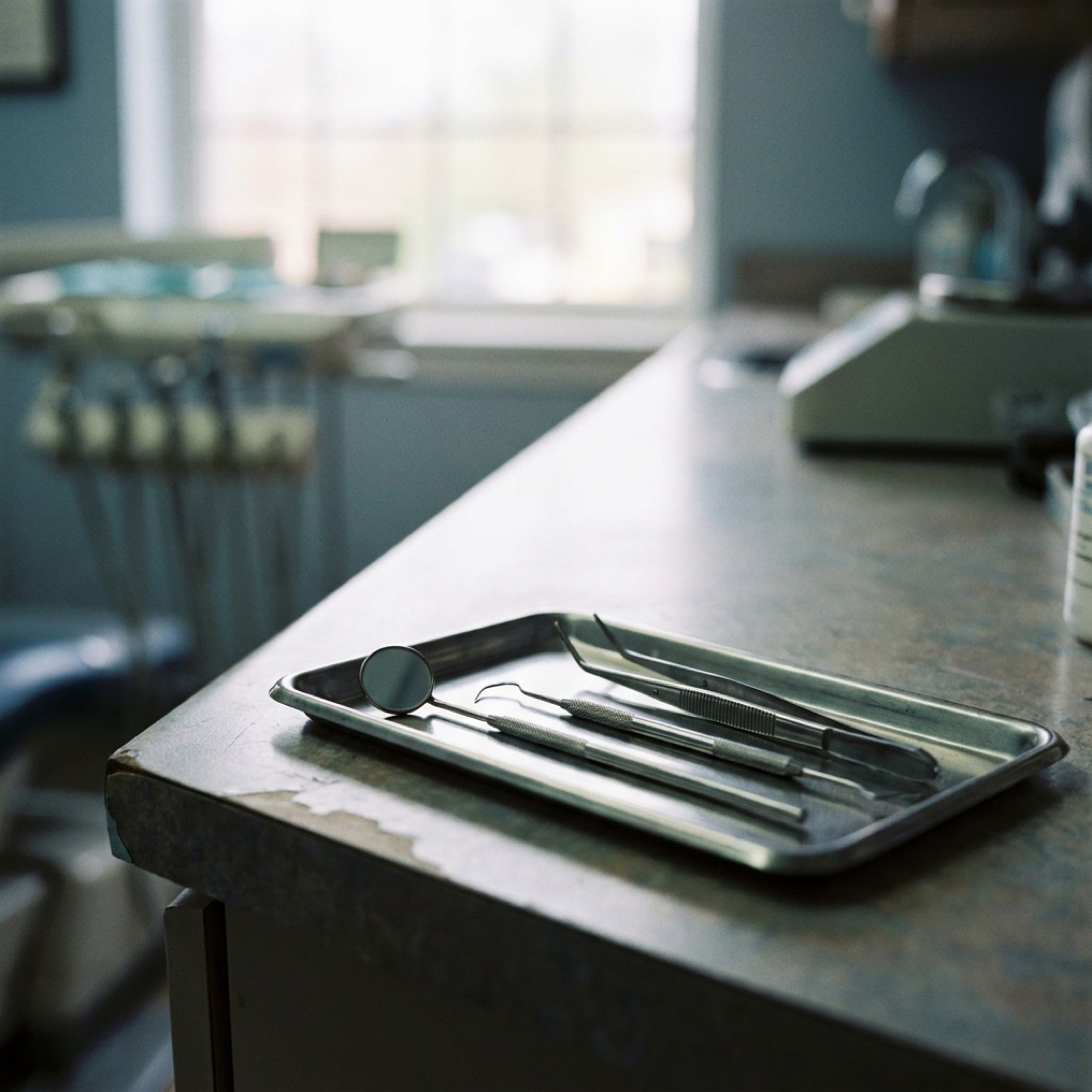 Macro detail of polished dental instruments arranged on a tray